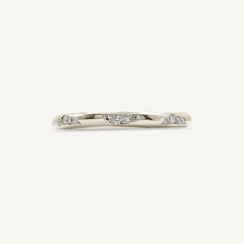 A lightly textured band with clusters of ethically sourced diamonds. Made from 100% recycled solid 14ct white gold, this wedding ring is modern yet timeless and is handmade by Robyn in her South London jewellery studio.
