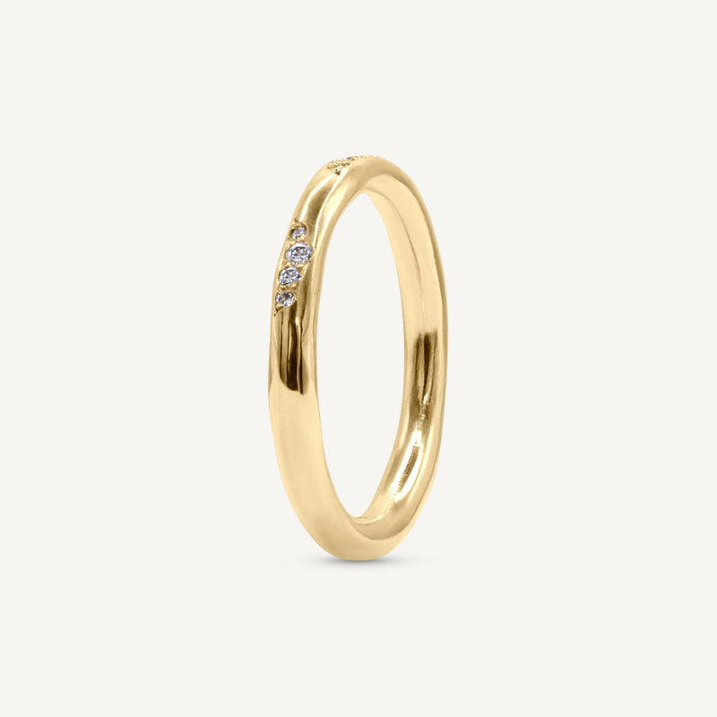A lightly textured band with clusters of ethically sourced diamonds. Made from 100% recycled solid 14ct gold, this wedding ring is modern yet timeless and is handmade by Robyn in her South London jewellery studio.