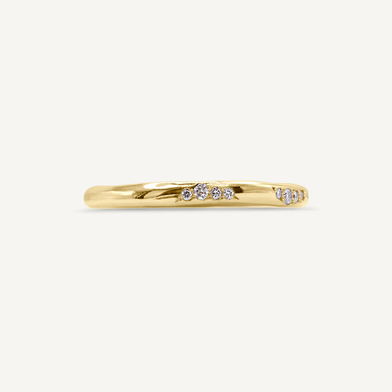 A lightly textured band with clusters of ethically sourced diamonds. Made from 100% recycled solid 14ct gold, this wedding ring is modern yet timeless and is handmade by Robyn in her South London jewellery studio.