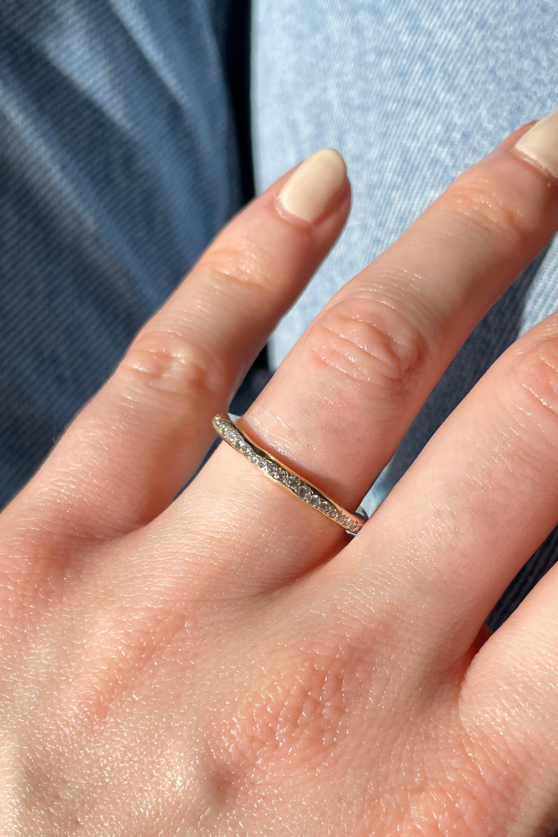 A modern and playful eternity ring set with diamonds half way around the band. 100% recycled solid 14ct gold and ethically sourced gemstones. Handmade by South London jeweller Robyn in her studio.