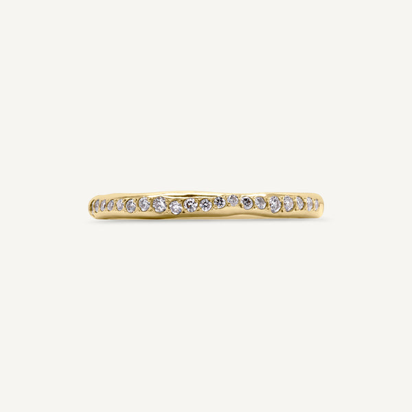 A modern and different eternity ring set with diamonds half way around the band. 100% recycled solid 14ct gold and ethically sourced gemstones. Handmade by South London jeweller Robyn in her studio.