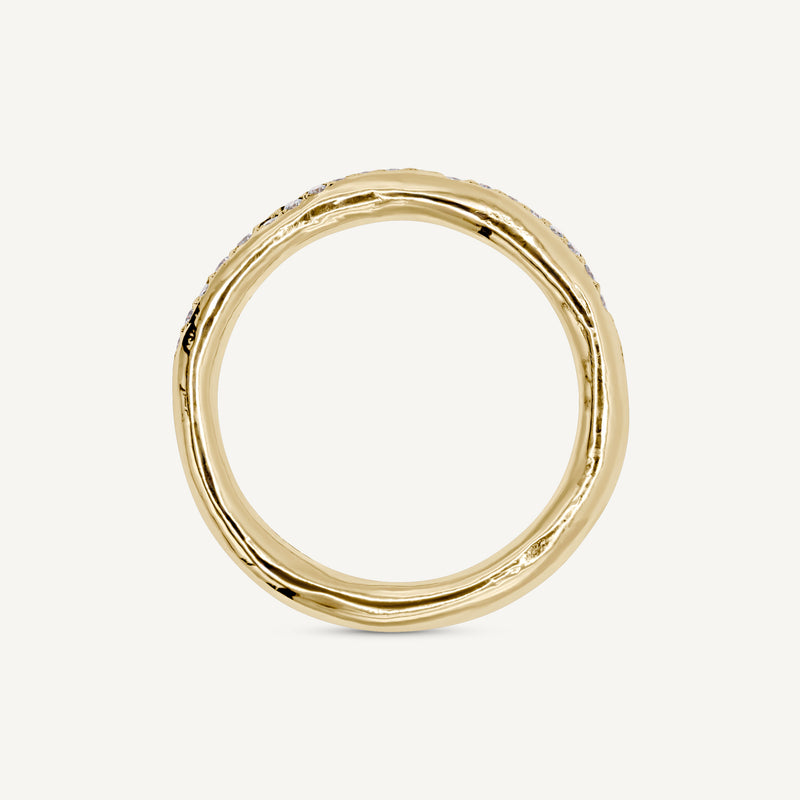 A modern and different eternity ring set with diamonds half way around the band. 100% recycled solid 14ct gold and ethically sourced gemstones. Handmade by South London jeweller Robyn in her studio.