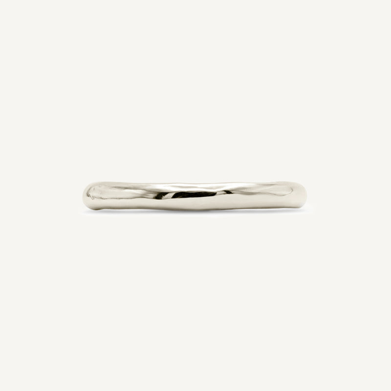 Solid 14ct yellow gold plain wedding ring with a classic timeless design. Inspired by hand-forged rings, this textured minimalistic band has a smooth polished finish. Unisex ring handmade in South London using 100% recycled gold.