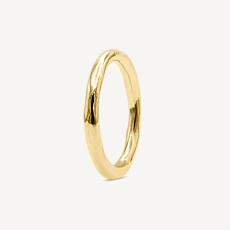 Solid 14ct yellow gold plain wedding ring with a classic timeless design. Inspired by hand-forged rings, this textured minimalistic band has a smooth polished finish. Unisex ring handmade in South London using 100% recycled gold.