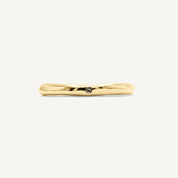A solid 14ct yellow gold wedding band handmade in South London using 100% recycled precious metals. Unisex design featuring an ethically sourced champagne diamond for added sparkle.