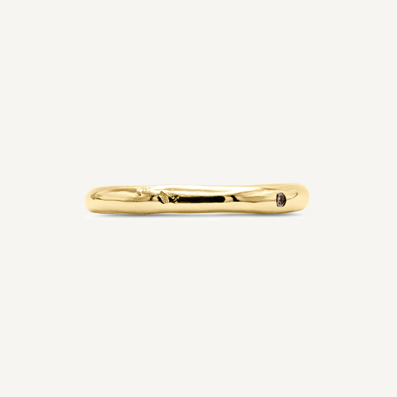 A solid 14ct yellow gold wedding band handmade in South London using 100% recycled precious metals. Unisex design featuring an ethically sourced champagne diamond for added sparkle.