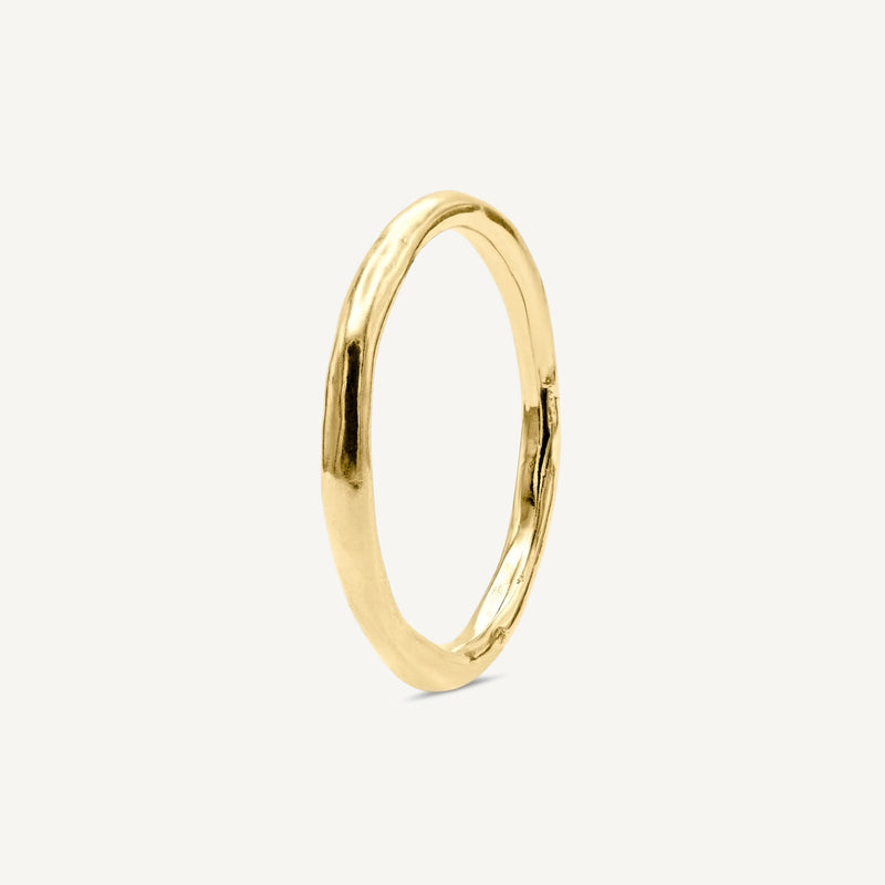 A subtle textured thin wedding ring is handmade from 100% recycled solid 14ct yellow gold, a timeless wedding ring choice. Made by South London jeweller Robyn Smith