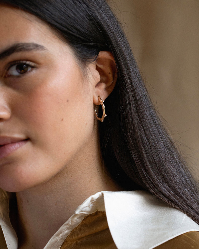 Rough yet refined bobble hoop earrings set with diamonds and tourmaline gemstones. Handmade using solid 14ct yellow gold in Robyn's South London studio.