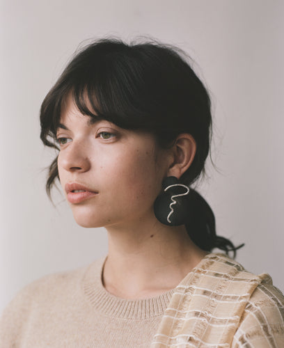 The ACRI earrings, from the collection Edition 08 made in collaboration with Birgit Toke Tauka Frietman. Ethically handmade in London using recycled silver and contrasting pieces of pressed horn. 