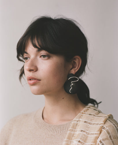 The ACRI earrings, from the collection Edition 08 made in collaboration with Birgit Toke Tauka Frietman. Ethically handmade in London using recycled silver and contrasting pieces of pressed horn.