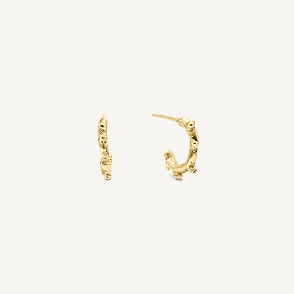 Small textured hoop earrings made in solid 14ct yellow gold. Stacking huggie hoops with unusual texture, these mini hoops are handmade in South London.