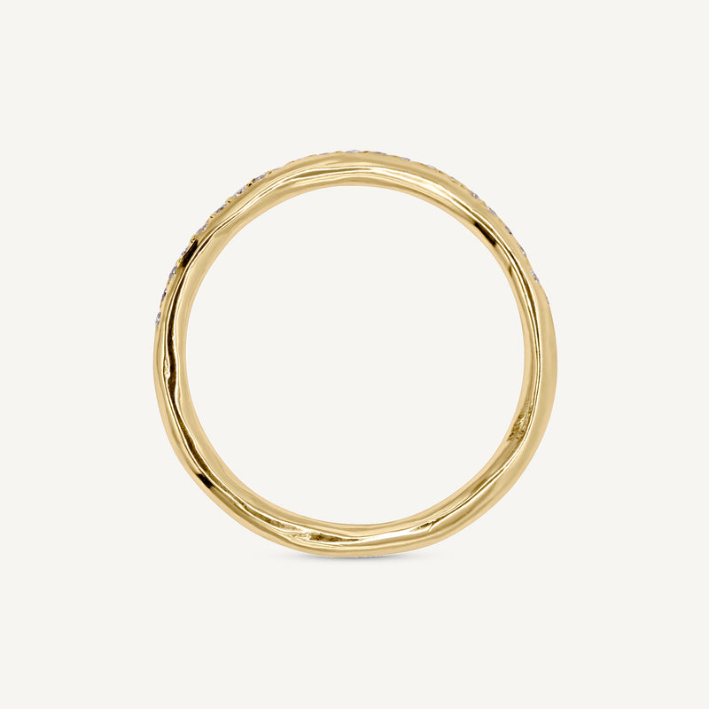 A modern and playful slim eternity ring set with a delicate line of diamonds half way around the band. 100% recycled solid 14ct gold and ethically sourced gemstones. Handmade by Robyn in her South London studio.