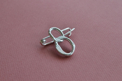 One-of-a-kind brooch pin, stamped with the soles of school gym shoes. Handmade in London using recycled silver.