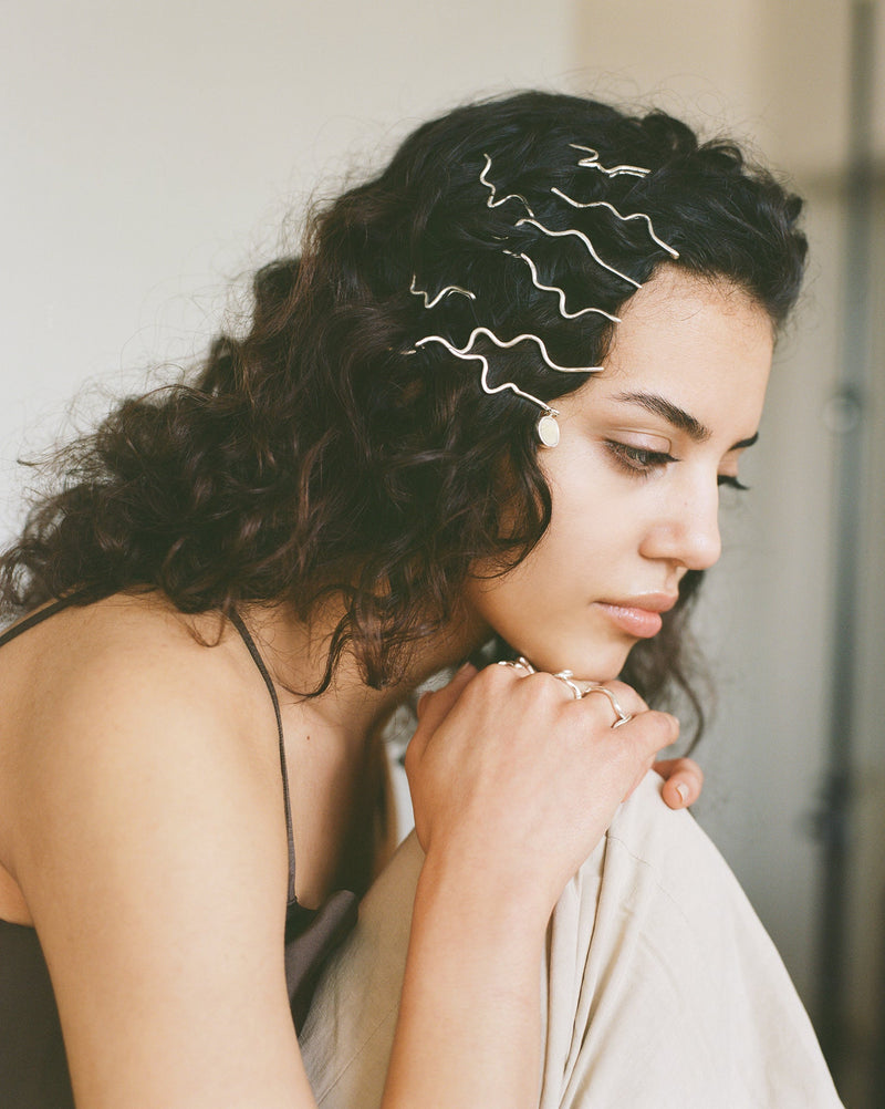 These statement recycled silver hair slides feature organic texture and a disc of ethically sourced highland horn, all ethically handmade in London by Folde Jewellery.