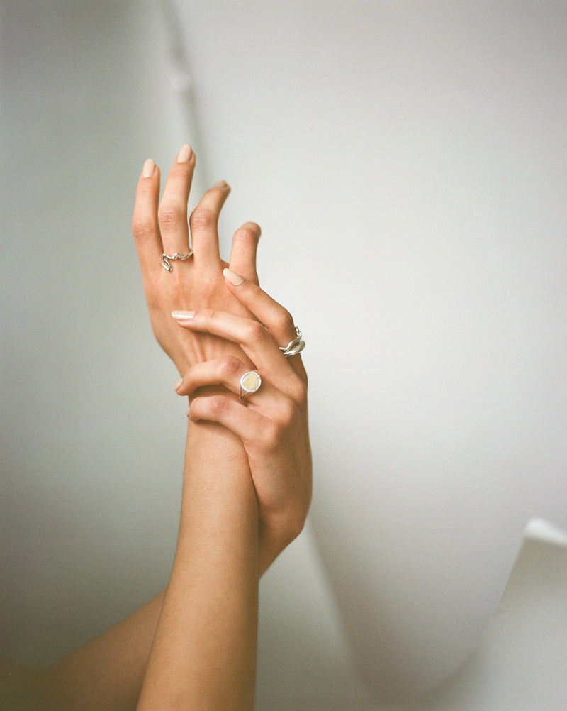The RAY ring is a chunky silver and horn signet ring with organic textured silver finish ethically handmade in London from recycled silver by Robyn Smith for Folde Jewellery
