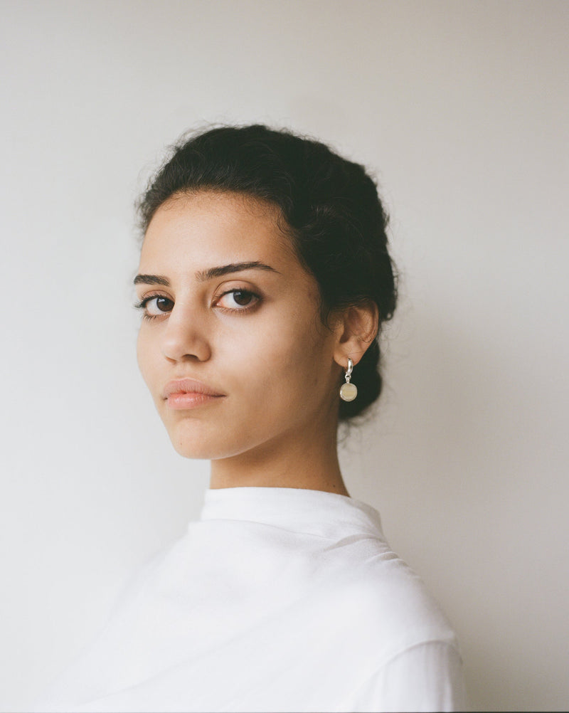 Sculptural statement silver hoop earrings handcrafted by Robyn Smith for Folde Jewellery in London ethically handmade using recycled silver and highland horn.