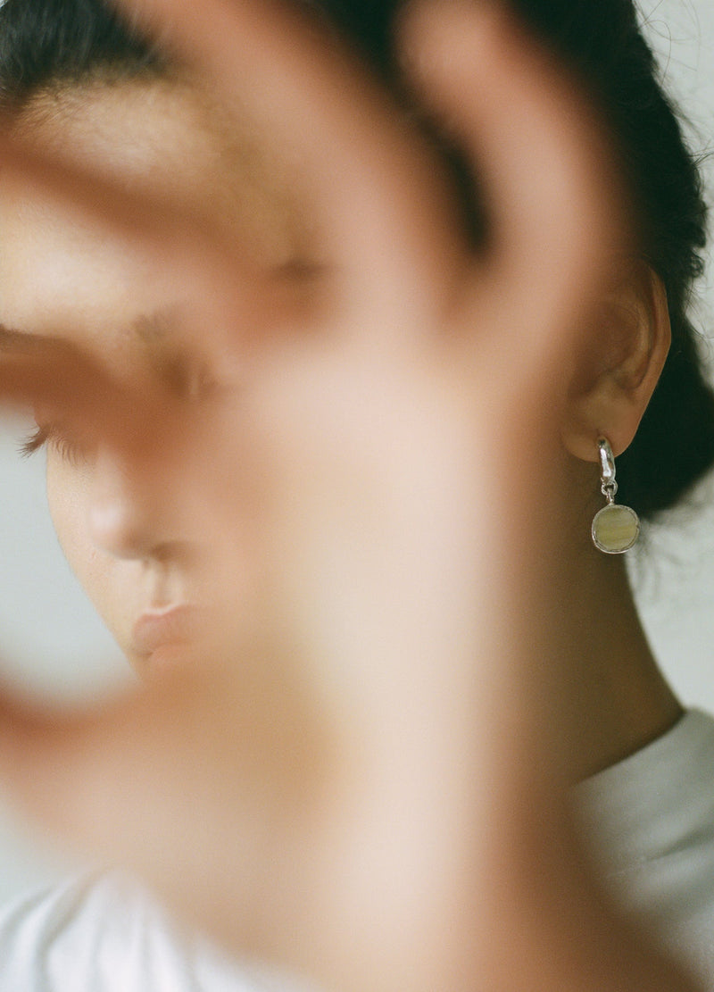 Sculptural statement silver hoop earrings handcrafted by Robyn Smith for Folde Jewellery in London ethically handmade using recycled silver and highland horn.