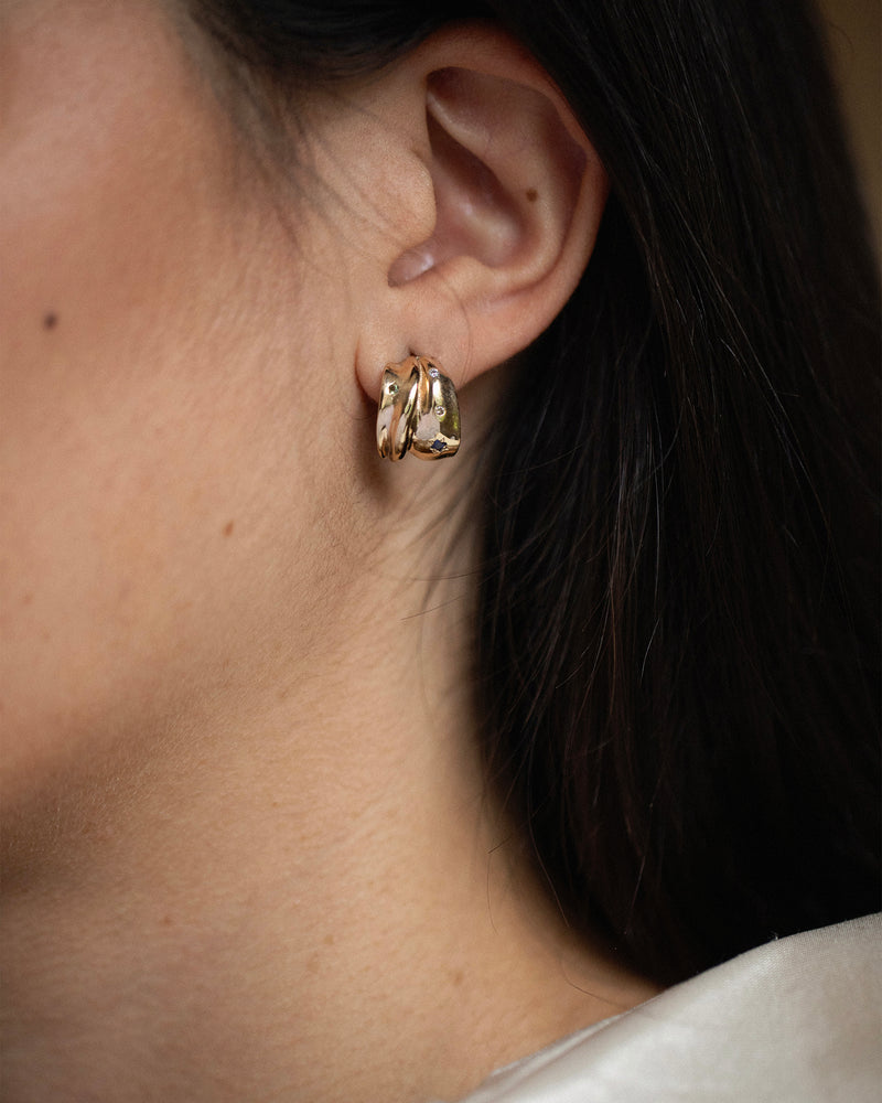 Folded solid 14ct yellow gold diamond hoop earrings set with diamonds, sapphires and tourmaline gemstones. Handmade in South London using 100% recycled gold and ethically sourced gemstones.