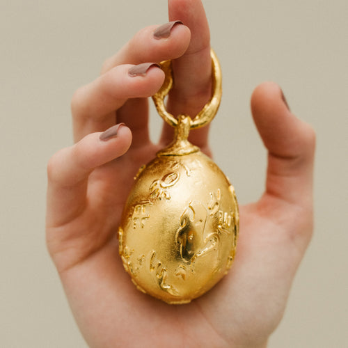 Bespoke Golden Egg, inspired by the masterfully crafted Fabergé eggs and the rough, unyielding textures of Byzantine coins. Handmade in London using recycled bronze and plated in 18ct Yellow Gold.