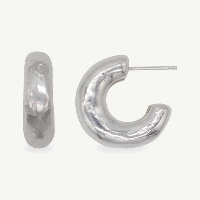 These chunky recycled silver statement hoop earrings with an organic texture are ethically handmade in London by Robyn Smith for Folde Jewellery.