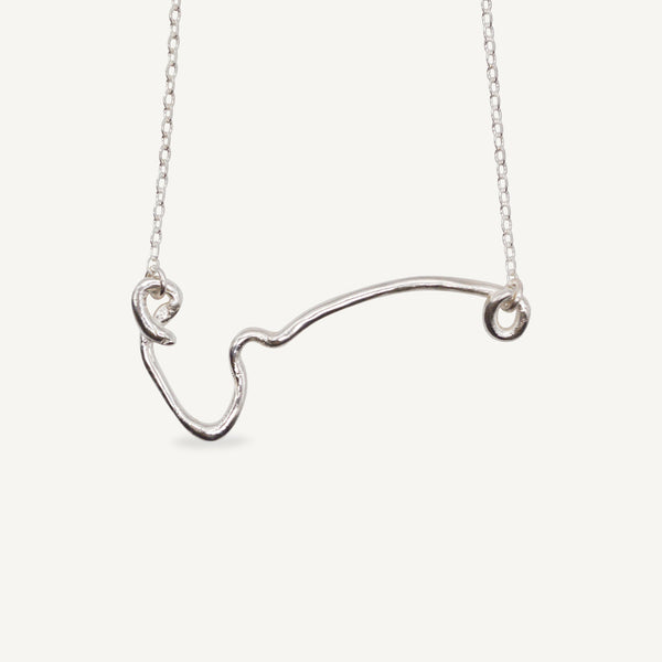 The IDA necklace is a sculptural elegant silver line necklace featuring organic texture ethically handmade in London from recycled silver by Robyn Smith for Folde Jewellery.